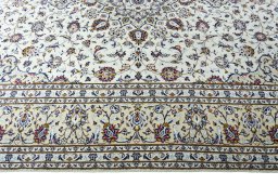 Corner detail of 2000s Kashan rug showing border pattern and Wool pile