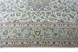 Corner detail of 2000s Kashan rug showing border pattern and Wool pile