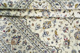 Corner detail of 2000s Kashan rug showing border pattern and Wool pile