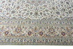 Corner detail of 2000s Kashan rug showing border pattern and Wool pile