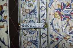 Backside of handmade 2000s Kashan rug showing knot structure and weave density