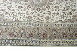 Corner detail of 2000s Kashan rug showing border pattern and Wool pile