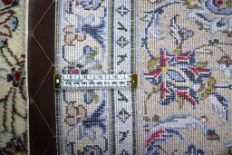 Backside of handmade 2000s Kashan rug showing knot structure and weave density