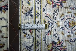Backside of handmade 2000s Kashan rug showing knot structure and weave density