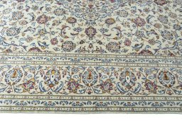 Corner detail of 2000s Kashan rug showing border pattern and Wool pile