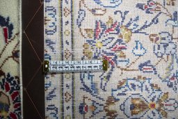 Backside of handmade 2000s Kashan rug showing knot structure and weave density