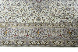 Corner detail of 2000s Kashan rug showing border pattern and Wool pile