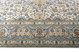 Corner detail of 2000s Kashan rug showing border pattern and Wool pile