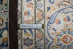 Backside of handmade 2000s Kashan rug showing knot structure and weave density