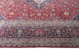 Corner detail of 2000s Kashan rug showing border pattern and Wool pile