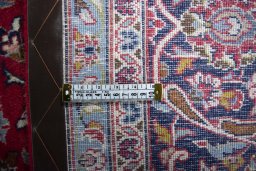 Backside of handmade 2000s Kashan rug showing knot structure and weave density