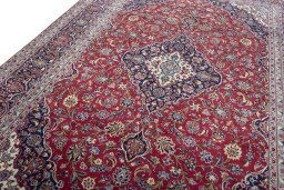 Backside of handmade 2000s Kashan rug showing knot structure and weave density