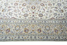 Corner detail of 2000s Kashan rug showing border pattern and Wool pile