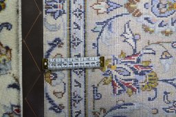 Backside of handmade 2000s Kashan rug showing knot structure and weave density