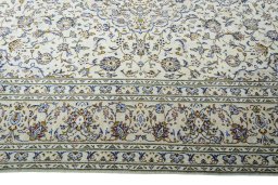 Corner detail of 2000s Kashan rug showing border pattern and Wool pile
