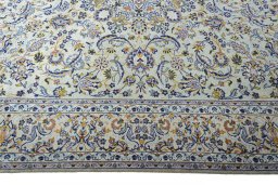 Corner detail of 2000s Kashan rug showing border pattern and Wool pile