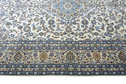Corner detail of 2000s Kashan rug showing border pattern and Wool pile