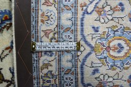 Backside of handmade 2000s Kashan rug showing knot structure and weave density