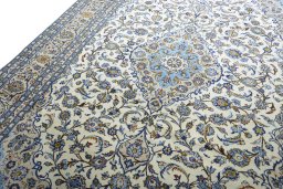 Backside of handmade 2000s Kashan rug showing knot structure and weave density