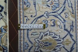 Backside of handmade 2000s Kashan rug showing knot structure and weave density