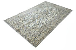 Corner detail of 2000s Kashan rug showing border pattern and Wool pile