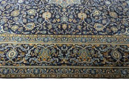 Corner detail of 2000s Kashan rug showing border pattern and Wool pile