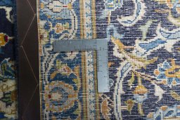 Backside of handmade 2000s Kashan rug showing knot structure and weave density