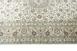 Corner detail of 2000s Kashan rug showing border pattern and Wool pile