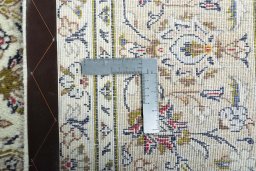 Backside of handmade 2000s Kashan rug showing knot structure and weave density