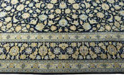Corner detail of 2000s Kashan rug showing border pattern and Wool pile