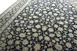 Backside of handmade 2000s Kashan rug showing knot structure and weave density
