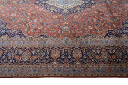 Corner detail of New Kashan rug showing border pattern and Cork pile
