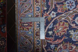Backside of handmade New Kashan rug showing knot structure and weave density