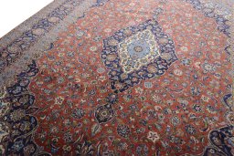 Backside of handmade New Kashan rug showing knot structure and weave density