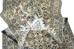 Corner detail of 2000s Kashan rug showing border pattern and Wool pile