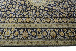 Corner detail of 2000s Kashan rug showing border pattern and Wool pile