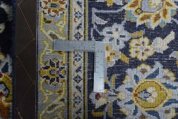 Backside of handmade 2000s Kashan rug showing knot structure and weave density