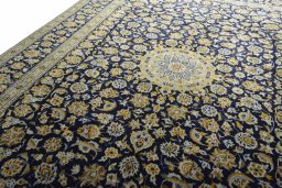Backside of handmade 2000s Kashan rug showing knot structure and weave density