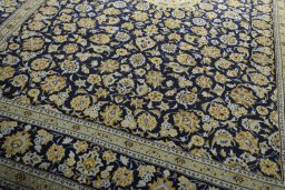 Close-up detail of 2000s Kashan rug from Iran / Persia showing Wool weave