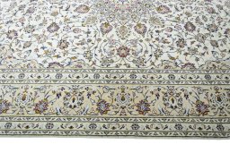 Corner detail of 2000s Kashan rug showing border pattern and Wool pile