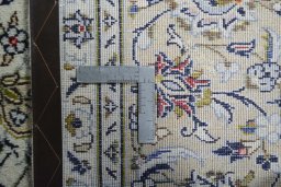Backside of handmade 2000s Kashan rug showing knot structure and weave density