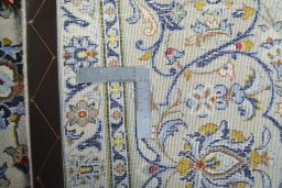Backside of handmade 2000s Kashan rug showing knot structure and weave density