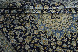 Close-up detail of 2000s Kashan rug from Iran / Persia showing Wool weave