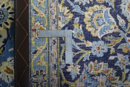 Backside of handmade 2000s Kashan rug showing knot structure and weave density