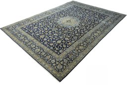 Corner detail of 2000s Kashan rug showing border pattern and Wool pile