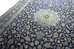 Backside of handmade 2000s Kashan rug showing knot structure and weave density