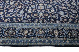 Corner detail of 2000s Kashan rug showing border pattern and Wool pile
