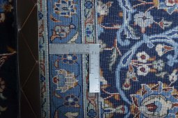 Backside of handmade 2000s Kashan rug showing knot structure and weave density