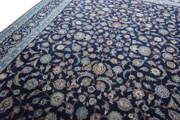 Backside of handmade 2000s Kashan rug showing knot structure and weave density