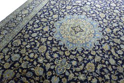 Backside of handmade 2000s Kashan rug showing knot structure and weave density